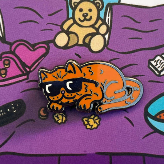 Hard enamel pin of a cute smushed face cat wearing sunglasses. By artist Frank Ape.